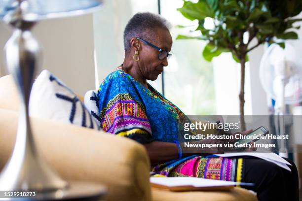 Dee Coleman makes notes before making a call to remind people about the enrollment dates of the Affordable Care Act and healthcare options, Saturday,...