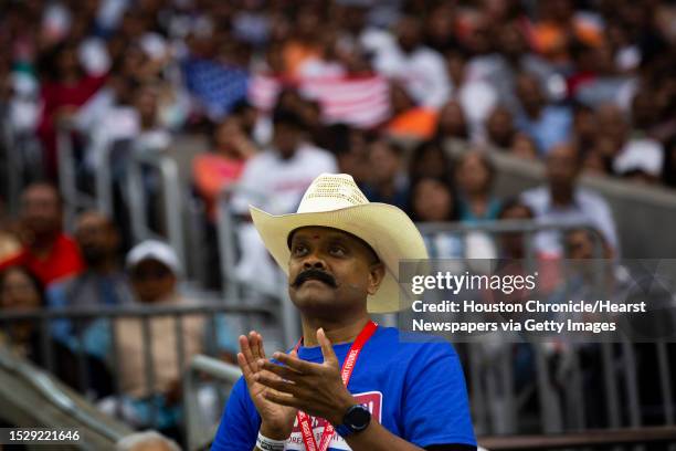 Supporter of India's Prime Minister Narendra Modi applauds while wearing a cowboy hat during the Howdy Modi event at NRG Stadium on Sunday, Sept. 22...