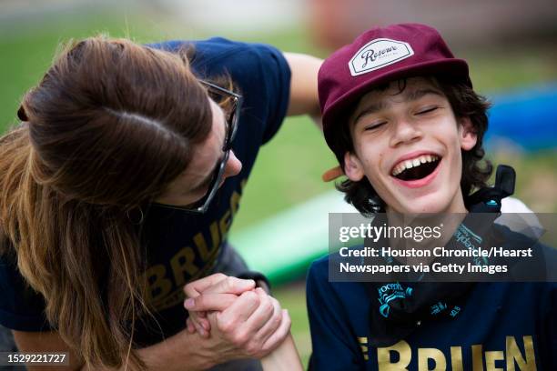 Kai Bruen and his mother Heather Bruen share a moment together while playing backyard games at the 2019 Houston WALK to End Hydrocephalus at The...