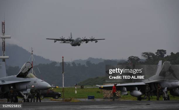 Air force C-130 cargo plane comes in to land past US marines F/A-18 Hornet fighter jets during the semi-annual Philippine-US military exercise dubbed...