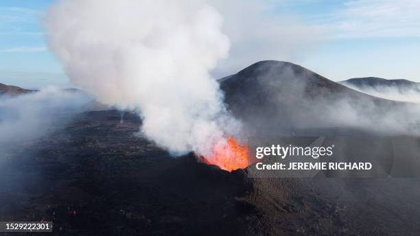 This picture taken on July 12, 2023 shows smoke billowing from lava during an volcanic eruption at Litli Hrutur, south-west of Reykjavik in Iceland....