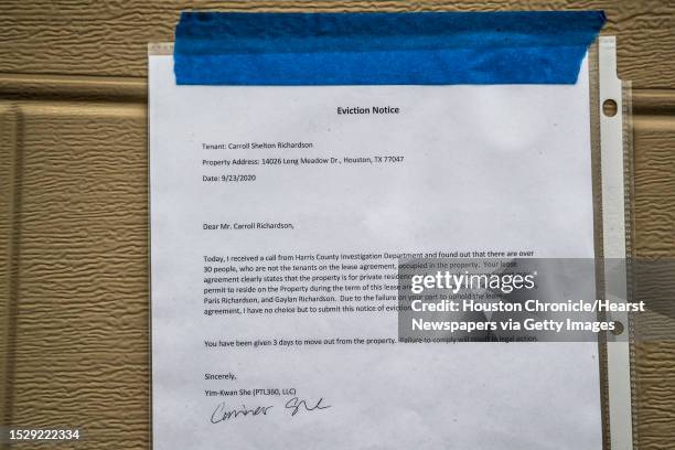 Eviction notice taped on the garage door of a property intended for Carroll Shelton Richardson from his landlord Thursday, Sept. 24 in Houston.