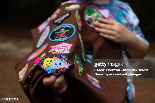 Girl Scout Troop 118037 member Emily Likeness shows her Okay to Say mental health badge, Wednesday, Sept. 1 in Atascocita.