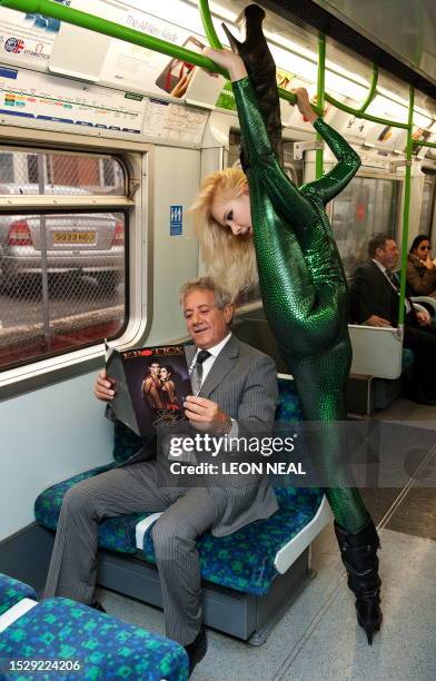 Contortionist "Zlata" from Kazakhstan , poses with the Chairman of Erotica, Savvas Christodoulou, on a London underground train during a photocall to...