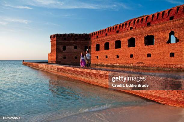 couple at fort jefferson moat wall. - citadel v florida stock pictures, royalty-free photos & images