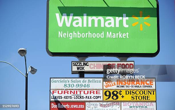 Walmart sign on the opening day of the new Walmart Neighborhood Market in Panorama City, California, a working class area about 13 miles northwest of...