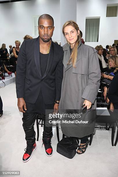 Kanye West and Gaia Repossi attend the Christian Dior Spring/Summer 2013 show as part of Paris Fashion Week on September 28, 2012 in Paris, France.
