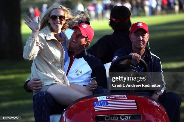 Webb Simpson of the USA rides a golf cart with his wife Dowd during the Afternoon Four-Ball Matches for The 39th Ryder Cup at Medinah Country Club on...