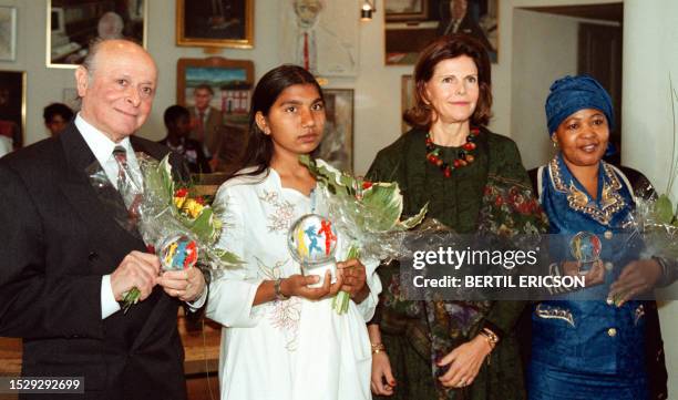 Queen Silvia of Sweden is flanked by Sobia Masih sister of murdered Pakistani activist Iqbal Masih who was killed aged 13, Buddy Elias cousin of Anne...