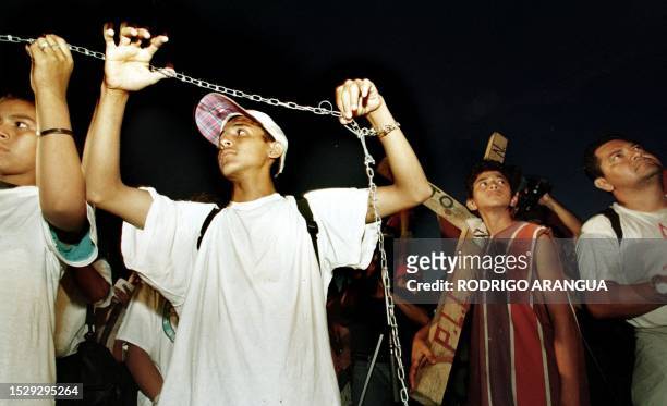 Group of teenagers protest 8 July 1999 in front of the government house. Un grupo de jovenes simulando estar encadenados protestan, el 08 de Julio de...