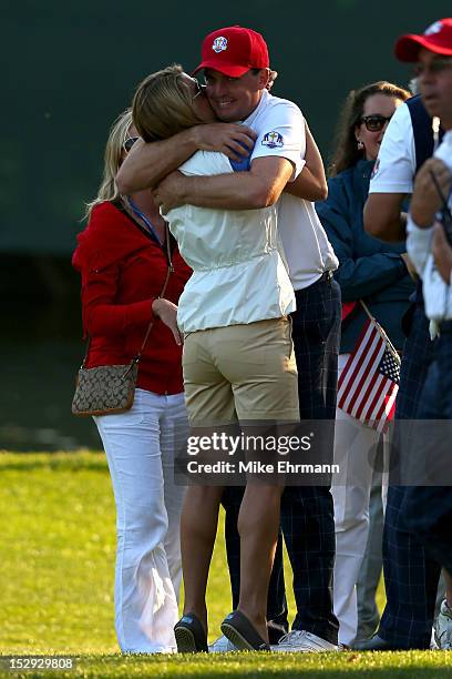 Keegan Bradley of the USA hugs his girlfriend Jillian Stacey on the 17th green after defeating the McIlroy/McDowell team 2&1 during the Afternoon...