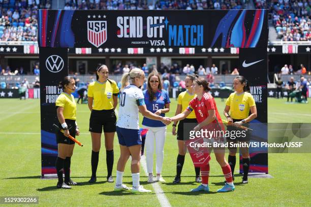 President Kimberly Lawrence conducts the coin toss with Lindsey Horan of the United States and Angharad James of Wales prior to an international...