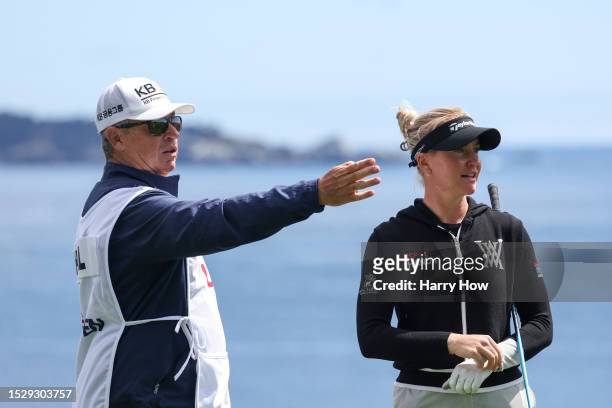 Charley Hull of England prepares to play her shot from the 14th tee with caddie Adam Woodward during the final round of the 78th U.S. Women's Open at...