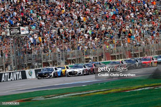 Aric Almirola, driver of the Smithfield/IHOP Ford, leads the field to the green flag to start the NASCAR Cup Series Quaker State 400 Available at...