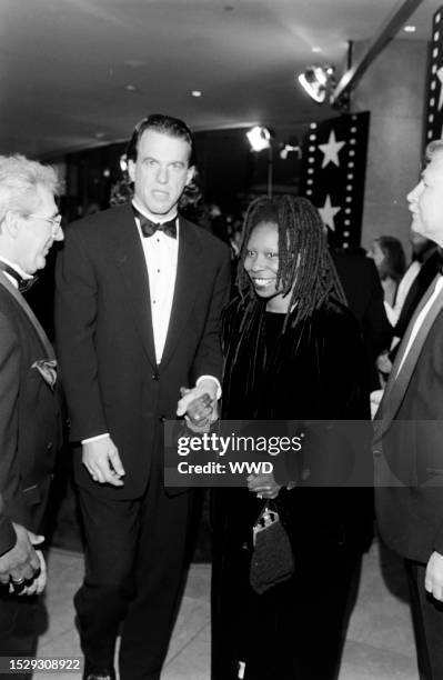 Lyle Trachtenberg , Whoopi Goldberg , and guests attend an event at the Beverly Hilton Hotel in Beverly Hills, California, on March 2, 1995.