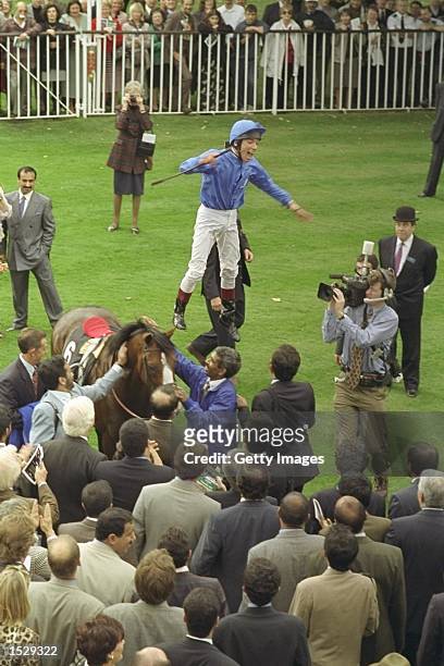 Frankie Dettori leaps off of Mark of Esteem after winning the Queen Elizabeth II stakes during his unique achievment of winning all seven races on...