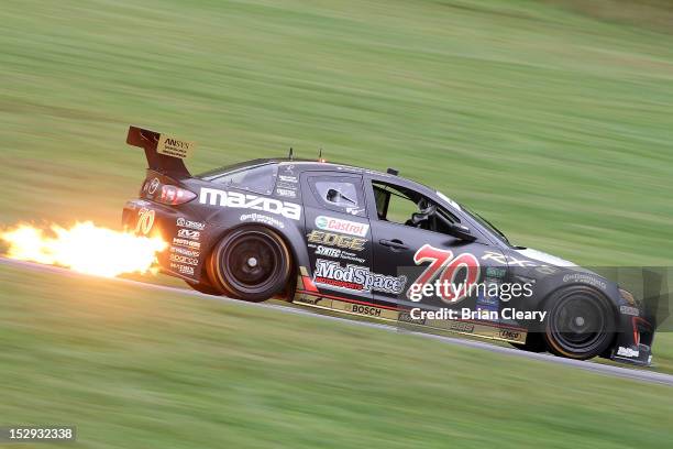 The Mazda of Sylvain Tremblay and Jonathan Bomartito races down a hill during practice at Lime Rock Park on September 28, 2012 in Lakeville,...