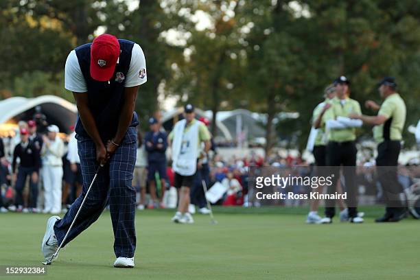 Tiger Woods of the USA reacts to a missed birdie putt on the 18th green during the Afternoon Four-Ball Matches for The 39th Ryder Cup at Medinah...
