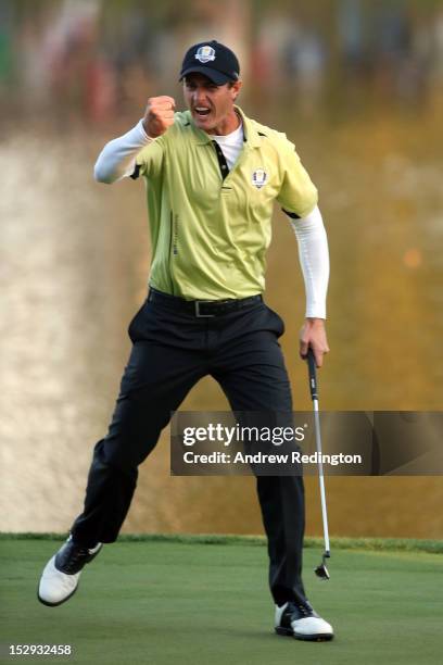 Nicolas Colsaerts of Europe celebrates a birdie putt on the 17th green during the Afternoon Four-Ball Matches for The 39th Ryder Cup at Medinah...