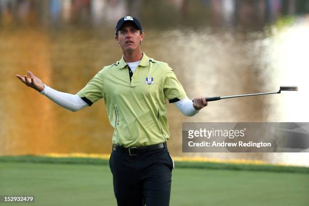 Nicolas Colsaerts of Europe celebrates a birdie putt on the 17th green during the Afternoon Four-Ball Matches for The 39th Ryder Cup at Medinah...