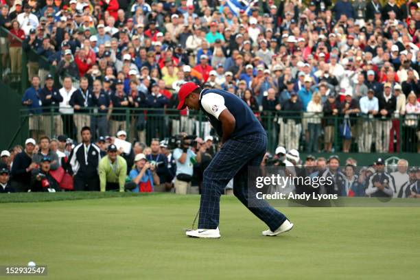 Tiger Woods of the USA reacts to a missed birdie putt on the 18th green during the Afternoon Four-Ball Matches for The 39th Ryder Cup at Medinah...