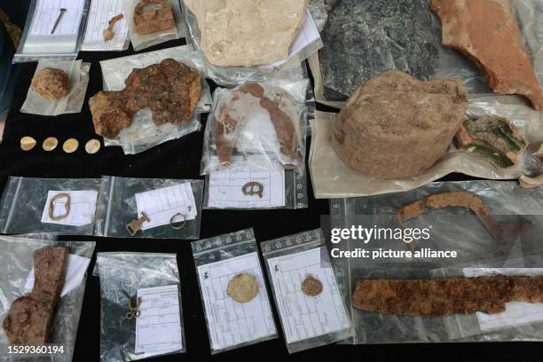 July 2023, Saxony-Anhalt, Wernigerode: View of numerous finds discovered by volunteers during archaeological investigations at the former...