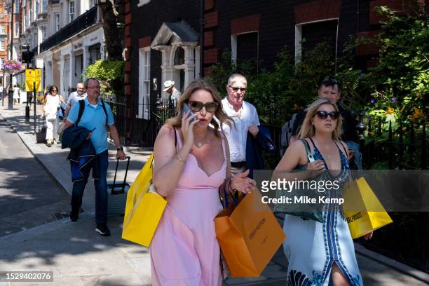 People with paper shopping bags in the exclusive area of Mayfair on 7th July 2023 in London, United Kingdom. Traditionally wealthy parts of West...