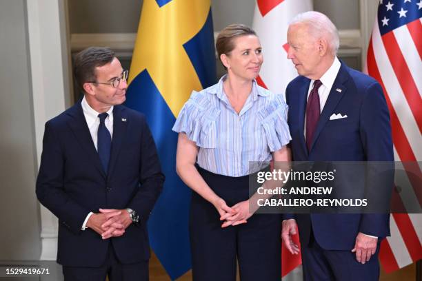 Sweden's Prime Minister Ulf Kristersson, Denmark's Prime Minister Mette Frederiksen and US President Joe Biden chat during the family photo of the...