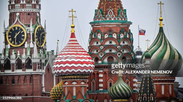 Photograph shows The Kremlin's Spasskaya tower and St. Basil's cathedral in downtown Moscow, on July 13, 2023. Russia will regard Western F-16...