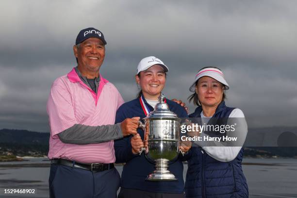 Allisen Corpuz of the United States celebrates with the Harton S. Semple Trophy alongside her father Marcs Corpuz and mother May Corpuz after winning...