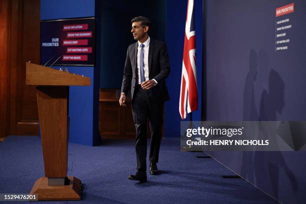 Britain's Prime Minister Rishi Sunak arrives to speak at a press conference at Number 9 Downing Street on public sector pay in London on July 13,...