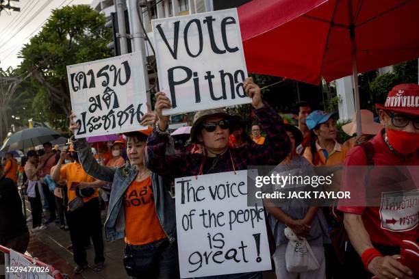 Move Forward party supporters hold up placards during a pro democracy protest outside Thailand's Parliament building in Bangkok on July 13 as...