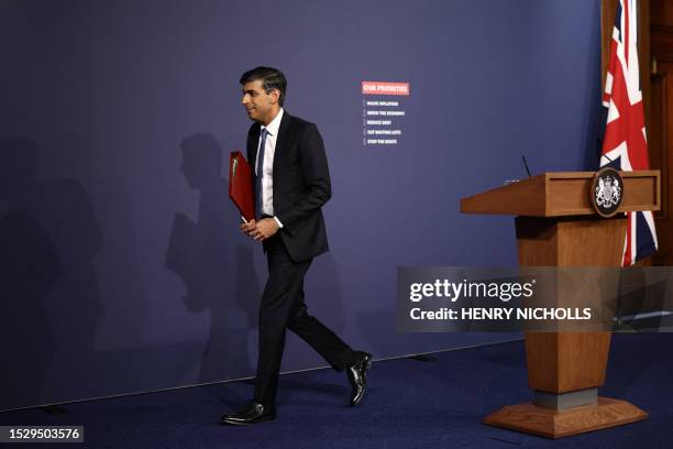 Britain's Prime Minister Rishi Sunak leaves after holding at a press conference at Number 9 Downing Street on public sector pay in London on July 13,...