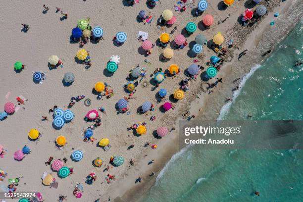 An aerial view of people swimming and sunbathing in Ilica Beach of Ä°zmir, Turkiye on July 12, 2023. Temperatures in Turkiye's Izmir, AydÄ±n, Manisa...