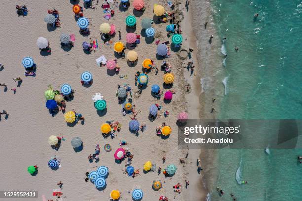 An aerial view of people swimming and sunbathing in Ilica Beach of Ä°zmir, Turkiye on July 12, 2023. Temperatures in Turkiye's Izmir, AydÄ±n, Manisa...