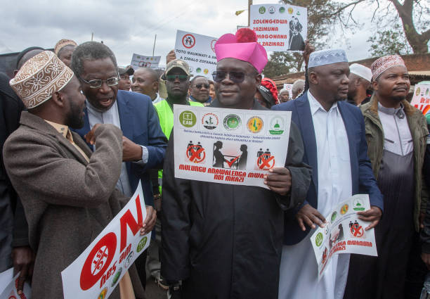 Archbishop George Desmond Tambala of the Lilongwe Catholic Archdiocese flanked by a Muslim Sheikh and other religious leaders, carries an anti LGBTQ...