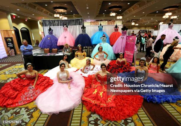 Girls modeling quinceanera dresses pose at the My 15 Expo on Sunday, Jan. 22 in Houston.