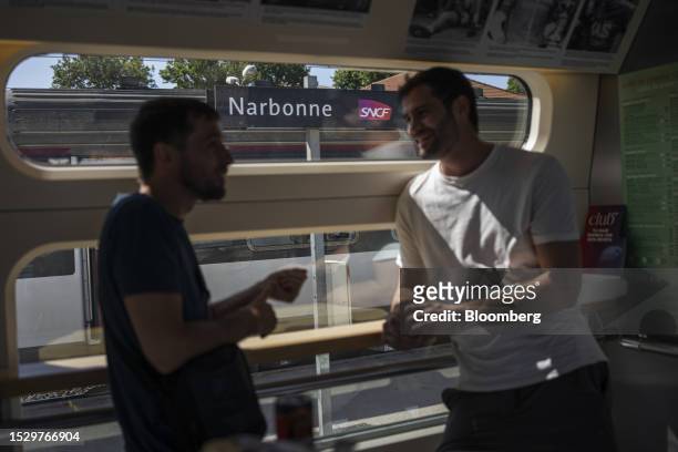 Passengers speak with each other in the restaurant car of the first Barcelona-Lyon train, operated by Renfe Operadora SC, at Narbonne railway station...