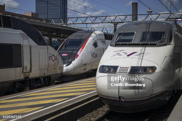 The first Barcelona-Lyon train, operated by Renfe Operadora SC, passes a Socite Nationale SNCF SA train at Lyon Part-Dieu railway station in Lyon,...