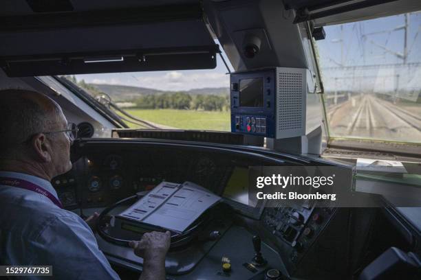 Train driver operates the first Barcelona-Lyon train, operated by Renfe Operadora SC, outside Montpellier Saint-Roche railway station in Montpellier,...