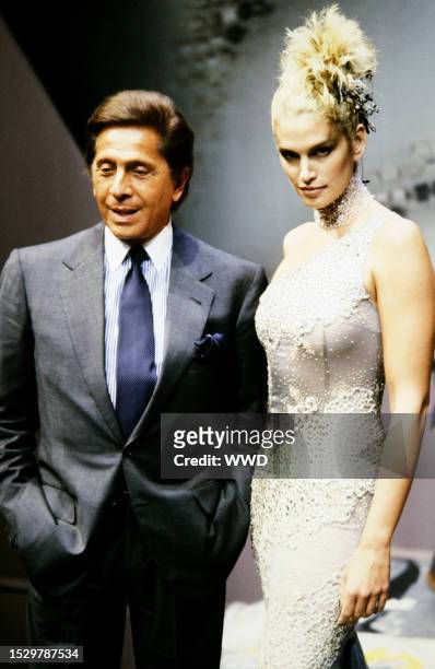 Model Cindy Crawford and designer Valentino Garavani walk the runway at the finale of the Valentino Fall 1997 Couture Runway Show on July 7 in Paris,...