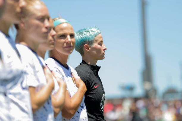 Megan Rapinoe of USA stands at the national anthem during an international friendly game between Wales and USWNT at PayPal Park on July 9, 2023 in...