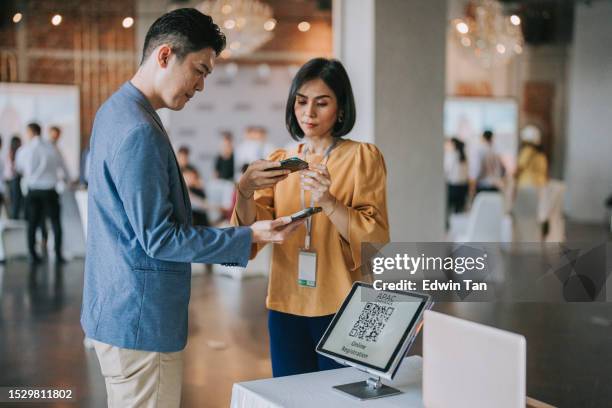 asian businessman mobile check in  registering for a business conference in a hotel's lobby - kick off call stock pictures, royalty-free photos & images