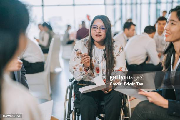 asian indian disabled woman in wheelchair participate in business conference workshop leading discussion - social inclusion stock pictures, royalty-free photos & images