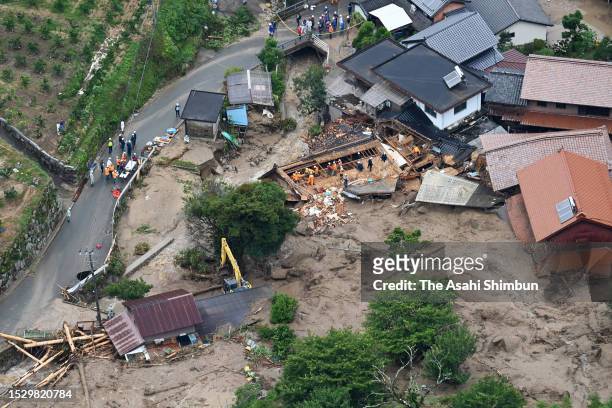 In this aerial image, rescue operation continues at a house where three people are missing after a landslide on July 10, 2023 in Karatsu, Saga,...