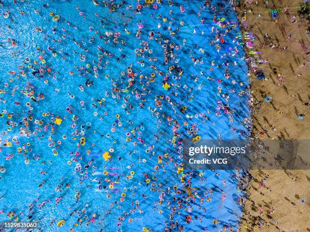 Aerial view of people cooling off at a water park during a hot summer day on July 8, 2023 in Nanjing, Jiangsu Province of China.