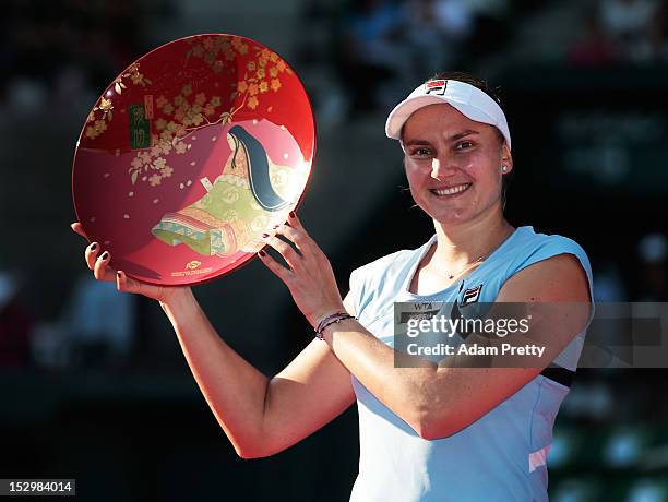 Nadia Petrova of Russia celebrates with the victory plate after victory over Agnieszka Radwanska of Poland in the womens final during day seven of...