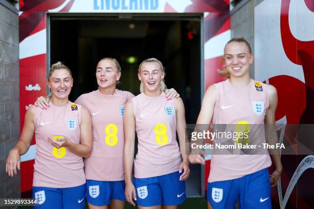 Laura Coombs, Alex Greenwood, Chloe Kelly and Esme Morgan of England walk out prior to a training session at the Sunshine Coast Stadium on July 10,...