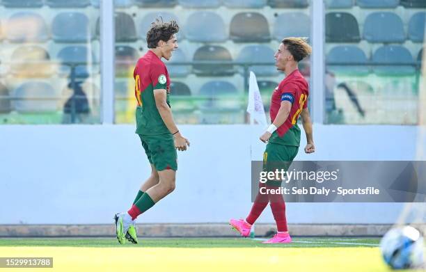 Gustavo Sá of Portugal, left, celebrates with teammate Hugo Félix after scoring their side's first goal during the UEFA European Under-19...