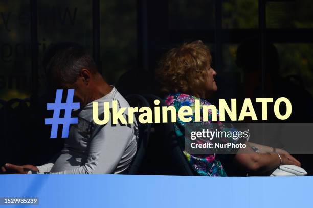 An inscription calling to join Ukraine to NATO is seen on a bus at the street a day after the NATO Summit in the city, in Vilnius, Lithuania on July...